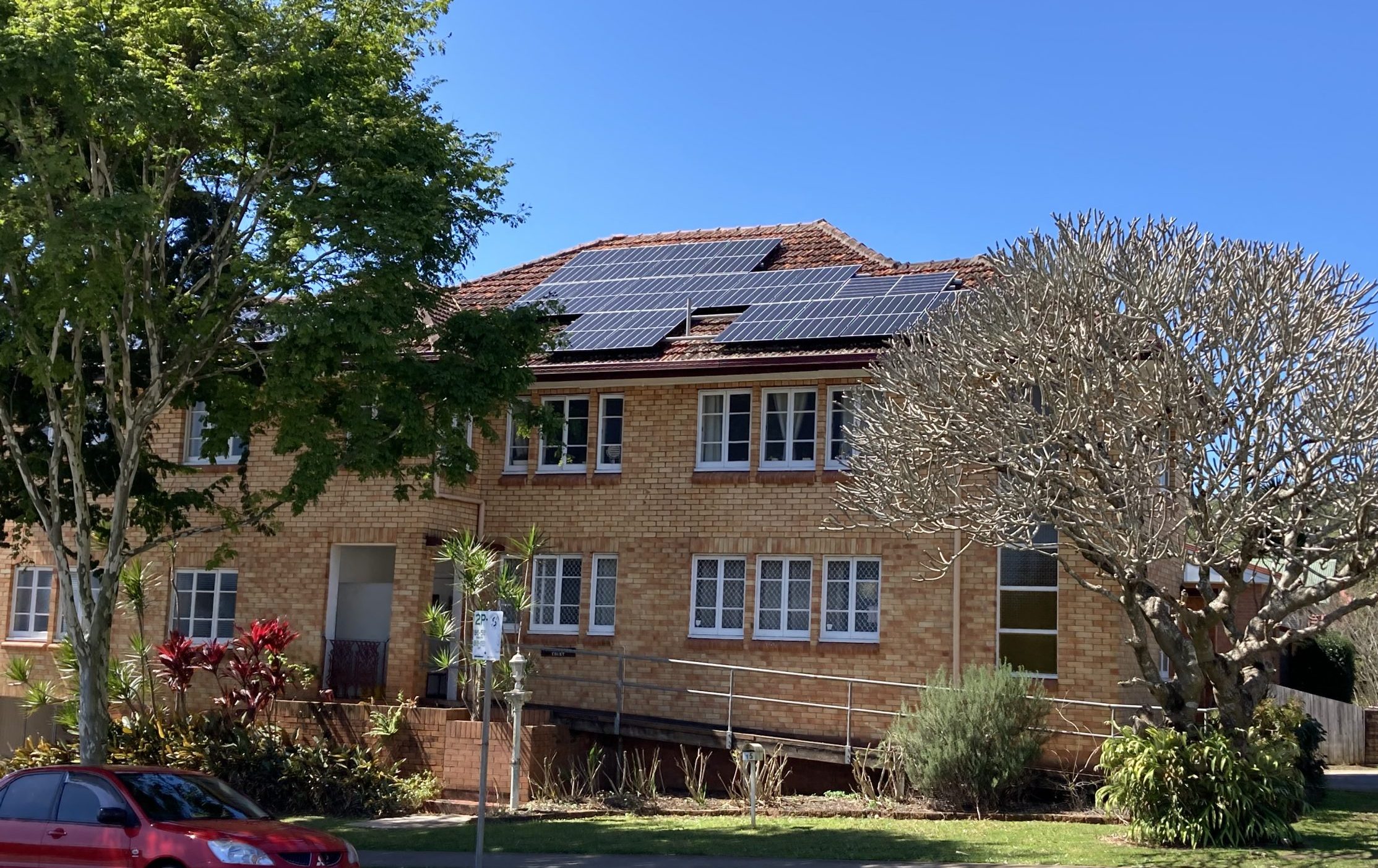 A double story brick house with solar panels